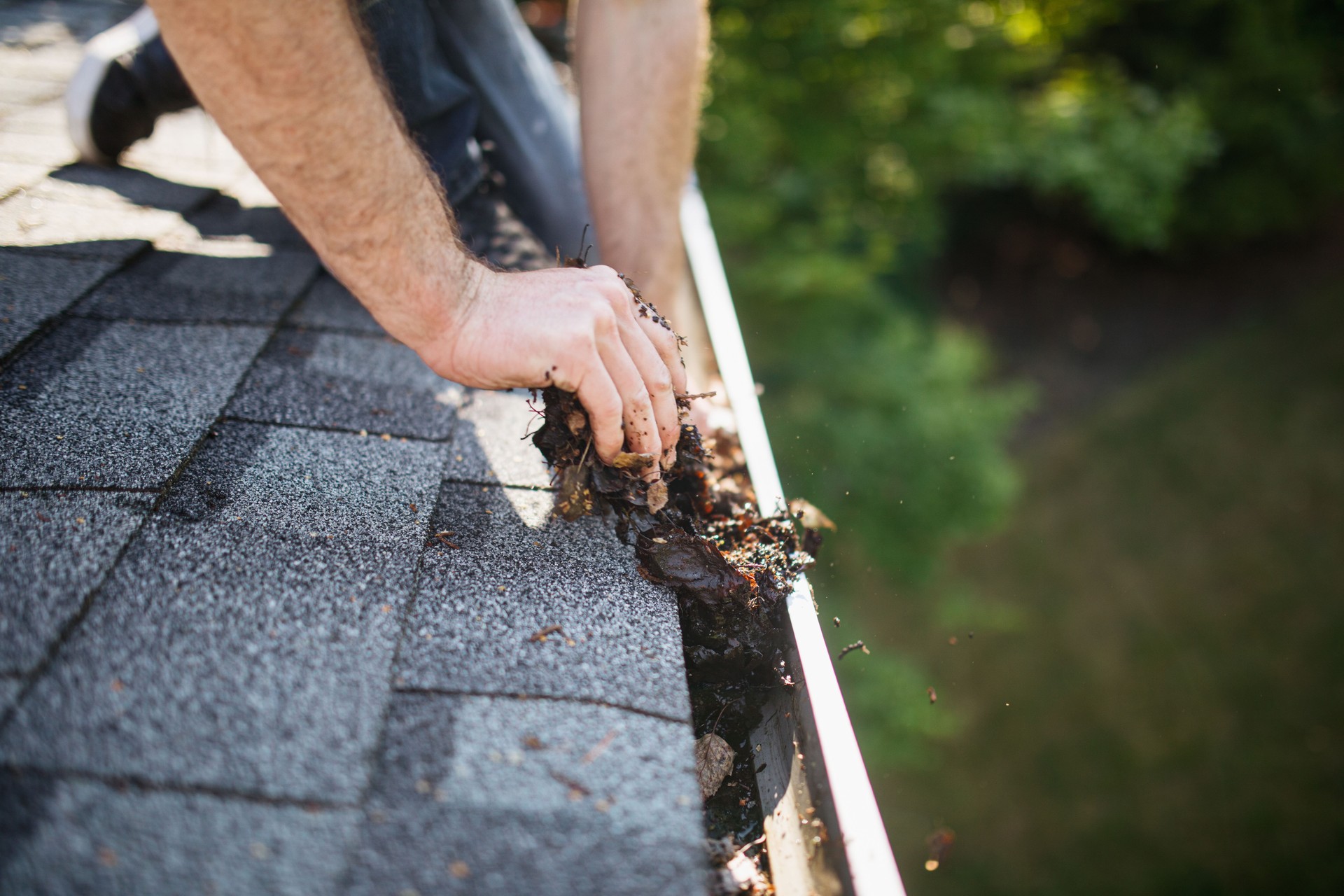 york pa Man Cleaning Out Roof Gutters on Home
