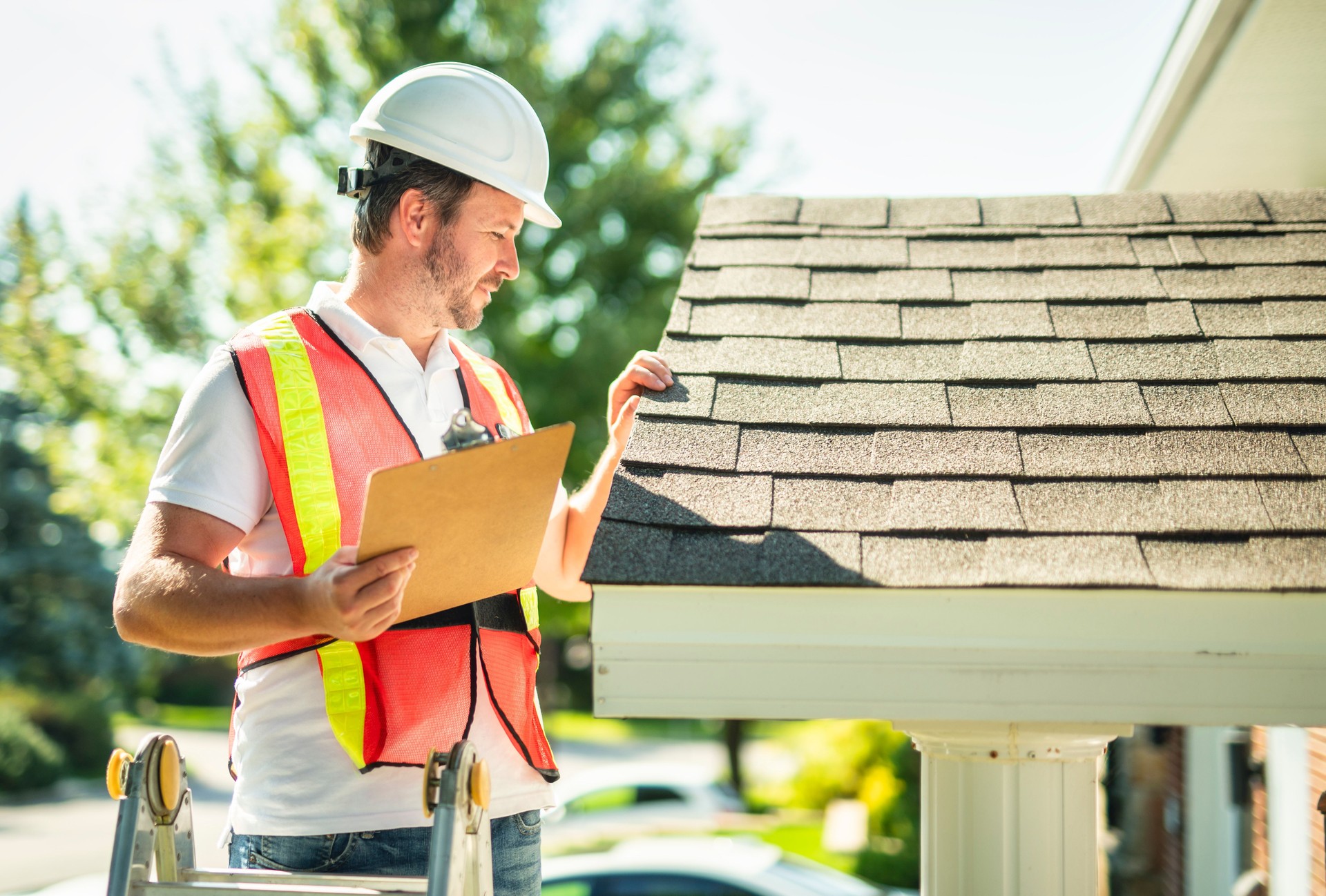 york pa man with hard hat standing on steps inspecting house roof